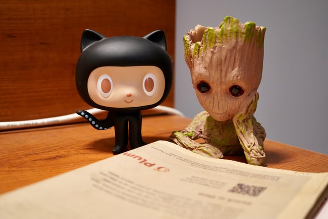 Octocat figurine next to Groot figurine